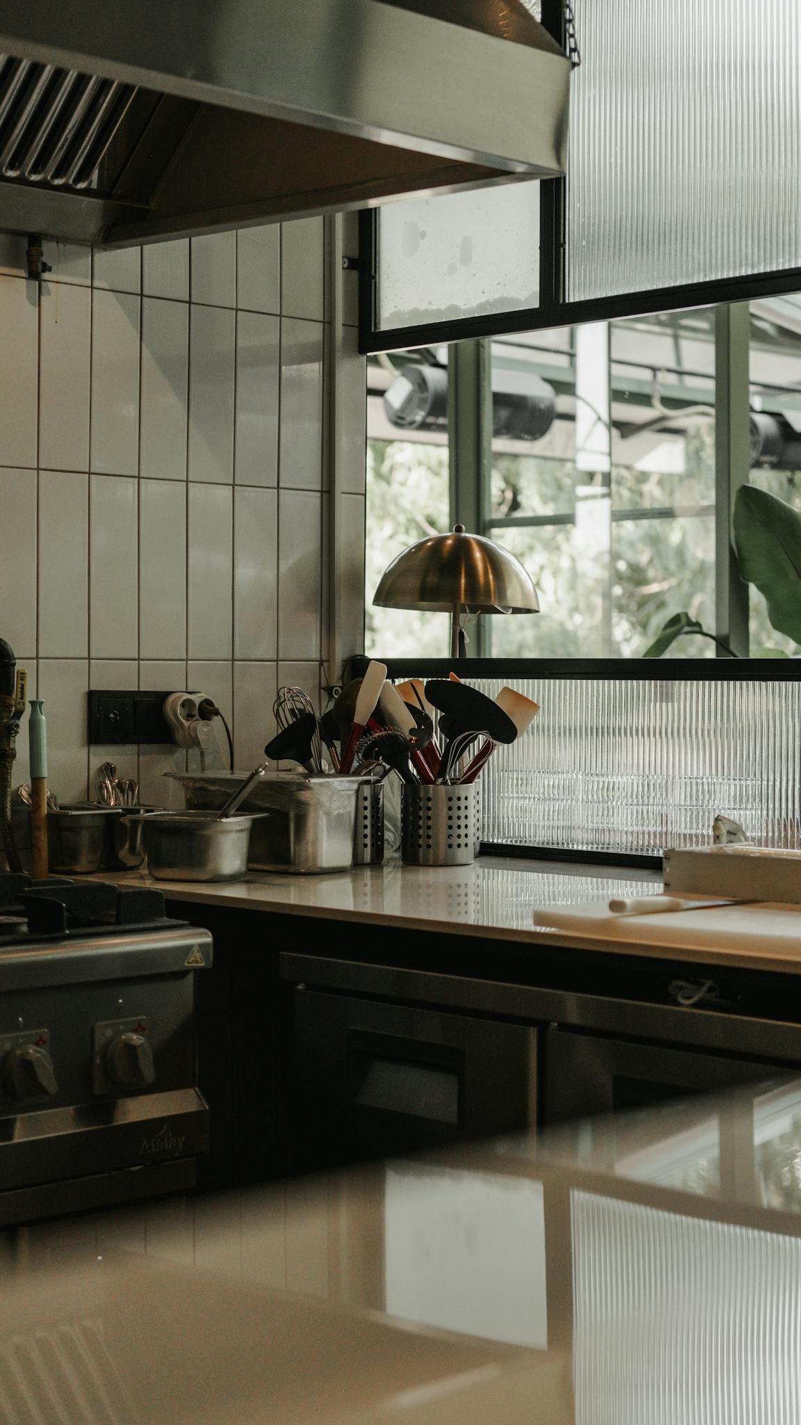 A sleek modern kitchen interior in Ankara, featuring stainless steel elements and contemporary design.
